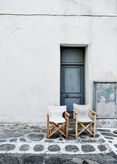 Fotografie blauwe deur met twee stoelen